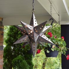 a metal star hanging from the side of a house