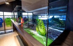 a display case filled with lots of different types of sports shirts and t - shirts