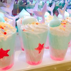 cupcakes with white frosting and colorful toppings on display in a store window