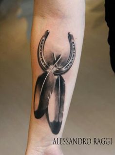 a black and white tattoo on the leg of a person with an arrow in it