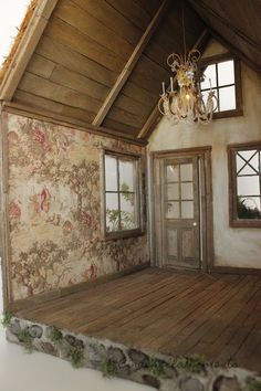 a doll house is shown with a chandelier hanging from it's ceiling