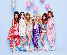 the girls are posing with balloons in their hair and wearing matching pajamas on blue background