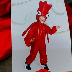 a card with an image of a child in a red costume