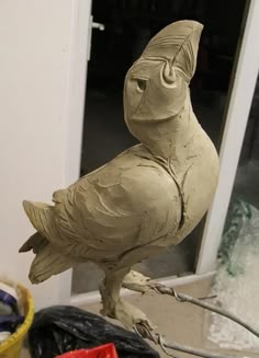 a clay owl sitting on top of a table