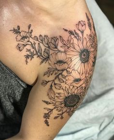 a woman's shoulder with flowers on it