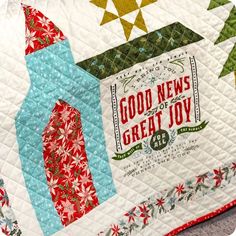 a quilted table topper with the words good news great joy on it