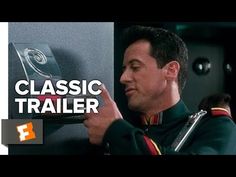 a man in uniform pointing to a wall with the words classic trailer written on it