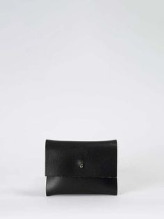 The loux wallet from kate sheridan is a compact and practical wallet made from beautiful italian vegetable tanned leather. featuring three internal sections and a sam brown front fastening this bestseller is small enough for your pocket or handbag but a perfect fit for cards coins and folded notes. seamlessly crafted in house at their clapton store by the kate sheridan team.    - black italian vegetable tanned leather with natural raw edges  - height: 9cm width: 11.5cm depth: 1.5cm  - unlined na Minimalist Leather Bifold Coin Purse, Minimalist Leather Coin Purse, Minimalist Leather Trifold Wallet For Everyday, Compact Leather Trifold Wallet For Everyday, Minimalist Leather Rectangular Coin Purse, Minimalist Rectangular Leather Coin Purse, Patagonia Outdoor, Folded Notes, Italian Vegetables