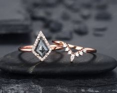 two diamond rings on top of a rock