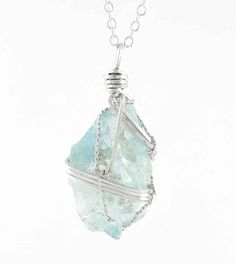 Nuggets of natural, watery-blue raw aquamarine crystals are hand-wrapped with swirls of elegant silver-plated wire to create these unique gemstone pendants. Material: Natural aquamarine & silver-plated wire Size: Varies, approximately 1-1/8" to 1-1/4" overall height (29-33 mm) Comes with a 20 inch long silver-plated chain (51 cm) 100 % Handmade Item number: wh365A Because these crystals are a natural product, each one is different and I am always careful to choose the prettiest side for the fron Feminine Necklace, Necklace Length Guide, Raw Aquamarine, Metal Clay Jewelry, Pendant Necklace Silver, Gemstone Pendants, Aquamarine Pendant, Crystal Pendant Necklace, Urn Necklaces