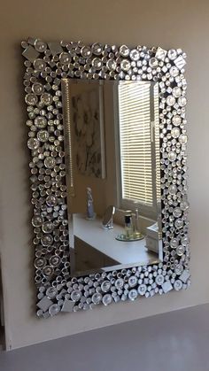 a mirror that is on the wall above a sink in a room with white walls