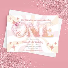 a pink and white birthday card with the word one on it, surrounded by stars