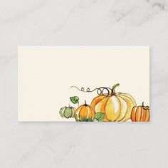 a white business card with pumpkins on the front and bottom, in watercolor