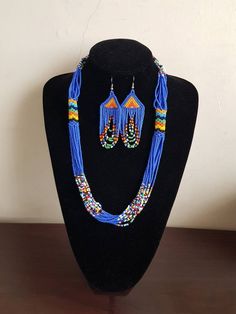 "Necklace comes with matching earrings. Dimensions: 27\" Main color: blue Available in different colors.  More necklaces here; https://www.etsy.com/shop/PrimeBeadsKe?ref=seller-platform-mcnav&section_id=33399833 All items are shipped through dhl express!" Blue Necklace With Colorful Dangle Beads, Blue Beaded Earrings As Gift, Traditional Blue Beaded Earrings With Colorful Beads, Blue Beaded Earrings With Polished Beads As Gift, Blue Polished Beaded Earrings For Gifts, Blue Dangle Necklaces With Polished Beads, Blue Large Beaded Dangle Necklaces, Blue Beaded Dangle Necklace With Large Beads, Blue Large Beads Dangle Necklace