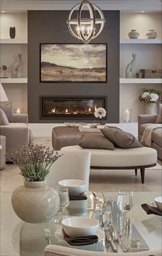 a living room filled with furniture and a fire place in the middle of the room