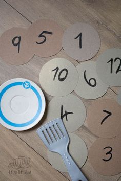 a table topped with lots of numbers and a fork next to a plate on the floor