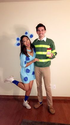 a man and woman dressed in costumes pose for a photo while standing next to each other