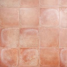 a close up view of an orange tile wall