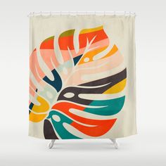 a shower curtain with an abstract design on the front and back of it, featuring colorful leaves