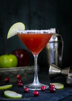 a drink in a coupe glass garnished with an apple slice