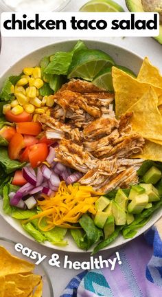 chicken taco salad in a bowl with tortilla chips on the side