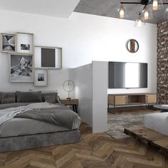 a bedroom with a bed, couch and television on the wall next to it's fireplace