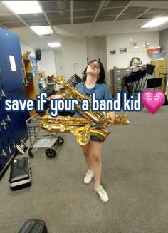 a woman holding a saxophone in an office with the words save if your a band kid