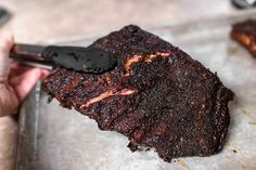 a person is cutting up some meat on a tray