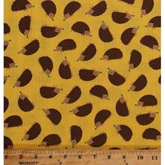 an animal print fabric with brown and black feathers on yellow, the background is very large