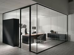 an office with glass walls and wooden floors