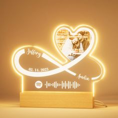 a personalized photo is displayed on a wooden stand with a heart shaped light up