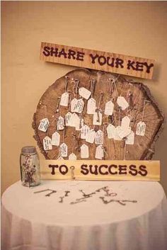 there is a wooden sign that says share your key to success on the side of a table