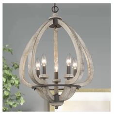 a chandelier with three lights hanging from it's center and two candles in the