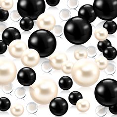 many black and white pearls are floating in the air