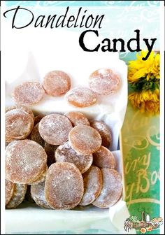 a bag full of powdered donuts sitting on top of a table next to a yellow flower