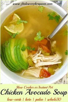 a bowl of chicken avocado soup with sliced lemons and cilantro