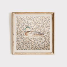 an image of a duck on a floral wallpaper pattern in a framed wooden frame