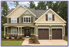 a large house with two garages in front of it