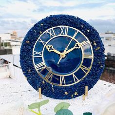 a blue and gold clock sitting on top of a building