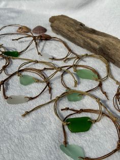 sea glass and driftwood are displayed on a white sheet