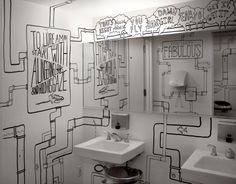 the bathroom is decorated in black and white with lots of doodles on the wall