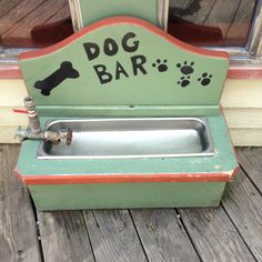 an old fashioned dog bar is painted green and orange