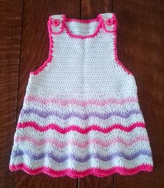 a crocheted dress with pink, purple and white stripes