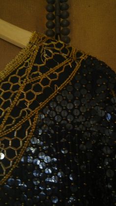 "80s Indian silk super sequined long sleeve blouse. Wide round neck surrounded by gold beads and sequins coming down into a large gold sequin flower design. Long flower design in gold sequins and beads down sides of both sleeves. Hem is gold beads. Back is same as front. Body of top is black sequins with small round gold beads in between. Silk outer and lining. Made by Barkha New York Size M Made in India length 24\" sleeves 22\", across bust 19\" (up to bust 38) **There are bare spots on the sh Velvet Shrug, Gold Sequin Blouse, Sequin Flower, Long Flowers, Sequin Blouse, Cute Notes, Decorative Trim, Gold Sequins, Pink Suede