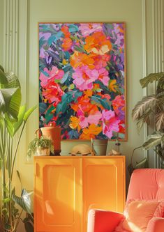 an orange chair in front of a painting and potted plants on a yellow cabinet