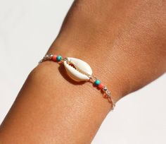 This boho bracelet is made with sterling silver chain adorned with turquoise and coral beads and one white natural cowrie shell. ➵ Perfect to wear alone or for layering with more bracelets.➵ The bracelet length is ajustable thanks to 5 cm (2 in) extender chain.➵ Matching cowrie choker: https://www.etsy.com/listing/536613831/cowrie-shell-sterling-silver-chain?ref=shop_home_active_1➵ Matching cowrie anklet: https://www.etsy.com/listing/538352307/sterling-silver-cowrie-shell-anklet?ref=shop_home_ac Cowrie Anklet, Cowrie Choker, Cowrie Shell Bracelet, Arm Bracelets, Nickel Free Jewelry, Turquoise And Coral, Shell Bracelet, Boho Bracelet, Silver Chain Bracelet