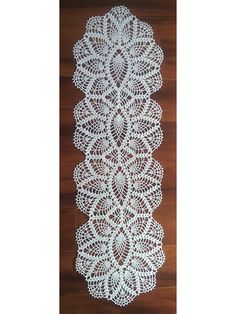 white crocheted doily on wooden floor