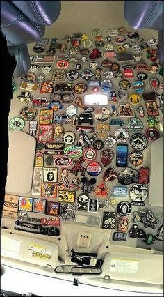 a bunch of different badges on the back of a car