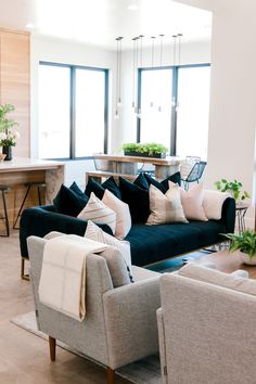 a living room filled with furniture and lots of windows