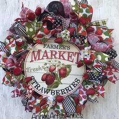 a farmers market wreath with strawberries on it